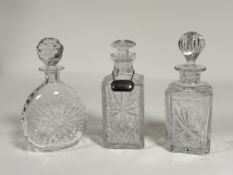 A collection of decanters comprising, one with spherical crystal decanter with stopper (h-26cm)