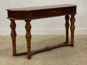 A traditional console table, fitted with a drawer and raised on turned supports united by an under