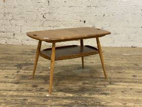 Ercol, an elm coffee table, the shaped top with pierced handle to each end, raised on turned and