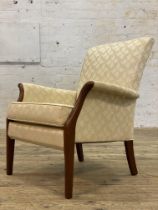 A Vintage Parker Knoll easy chair, upholstered in floral decorated ivory fabric. H80cm.