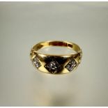 A 18ct gold ring set three diamond shaped panels, two set with four rose cut diamonds the center set