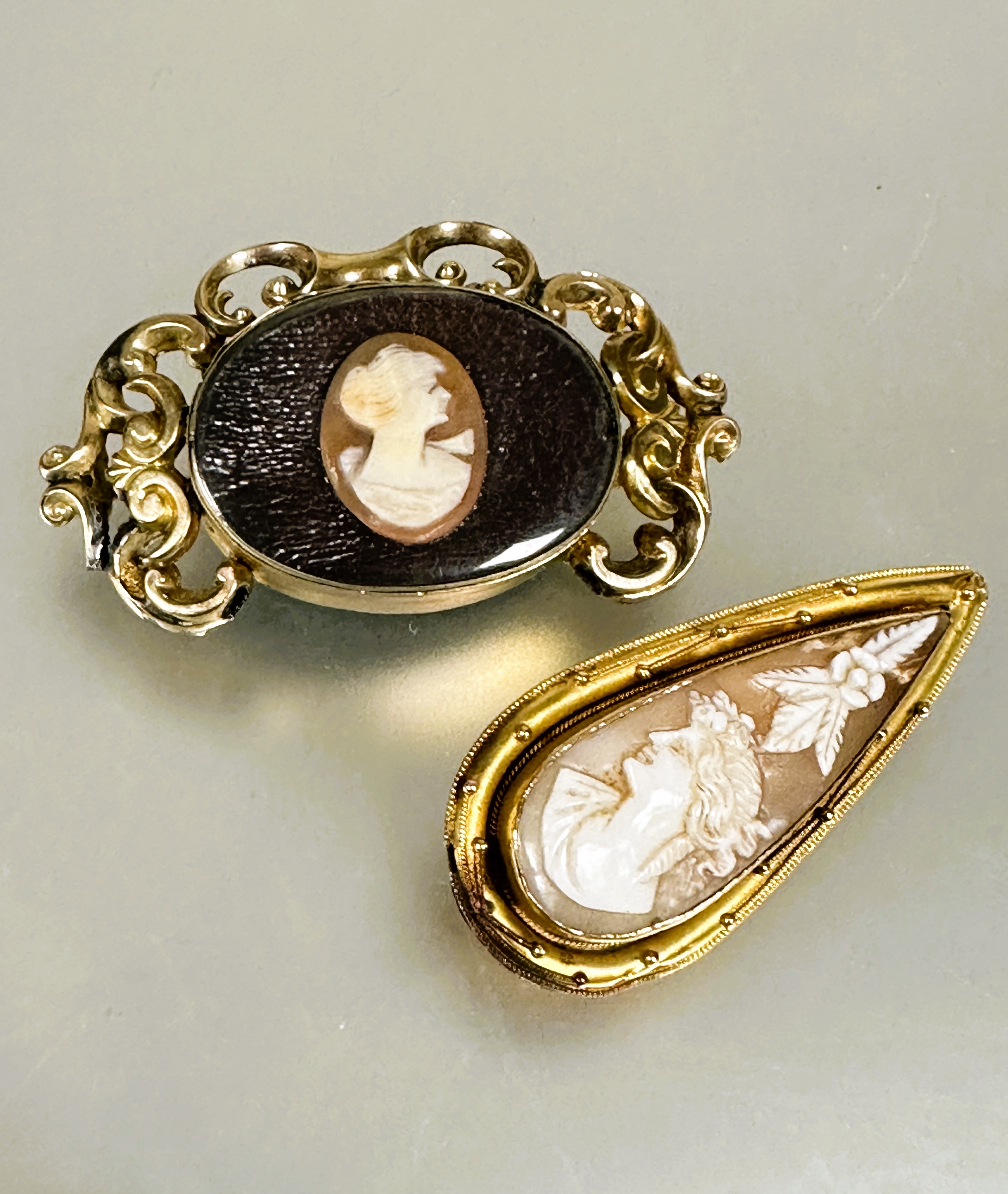 A Late Victorian yellow metal tear drop brooch mounted shell carved cameo panel depicting a female