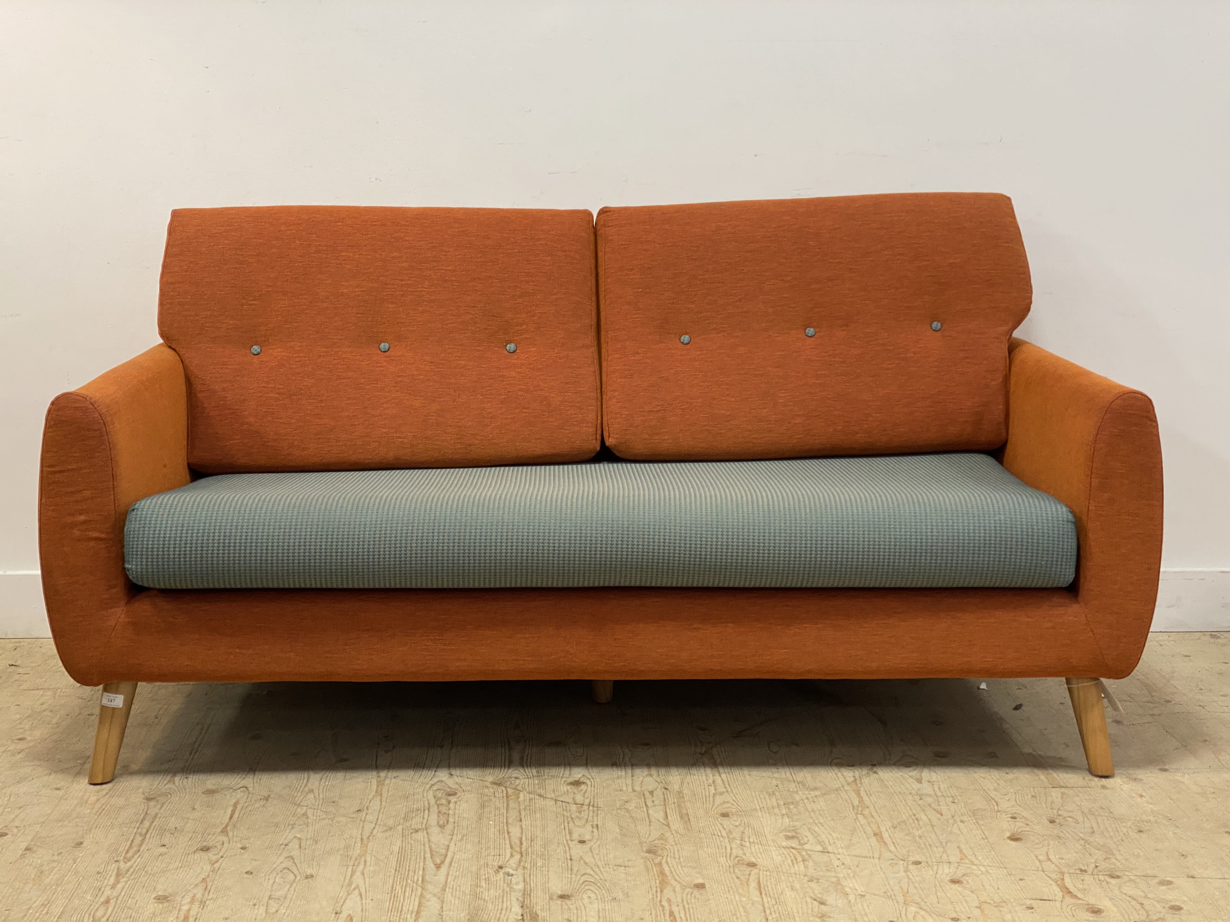 G-plan, a contemporary three seat sofa, vibrantly upholstered and raised on turned, tapered, and