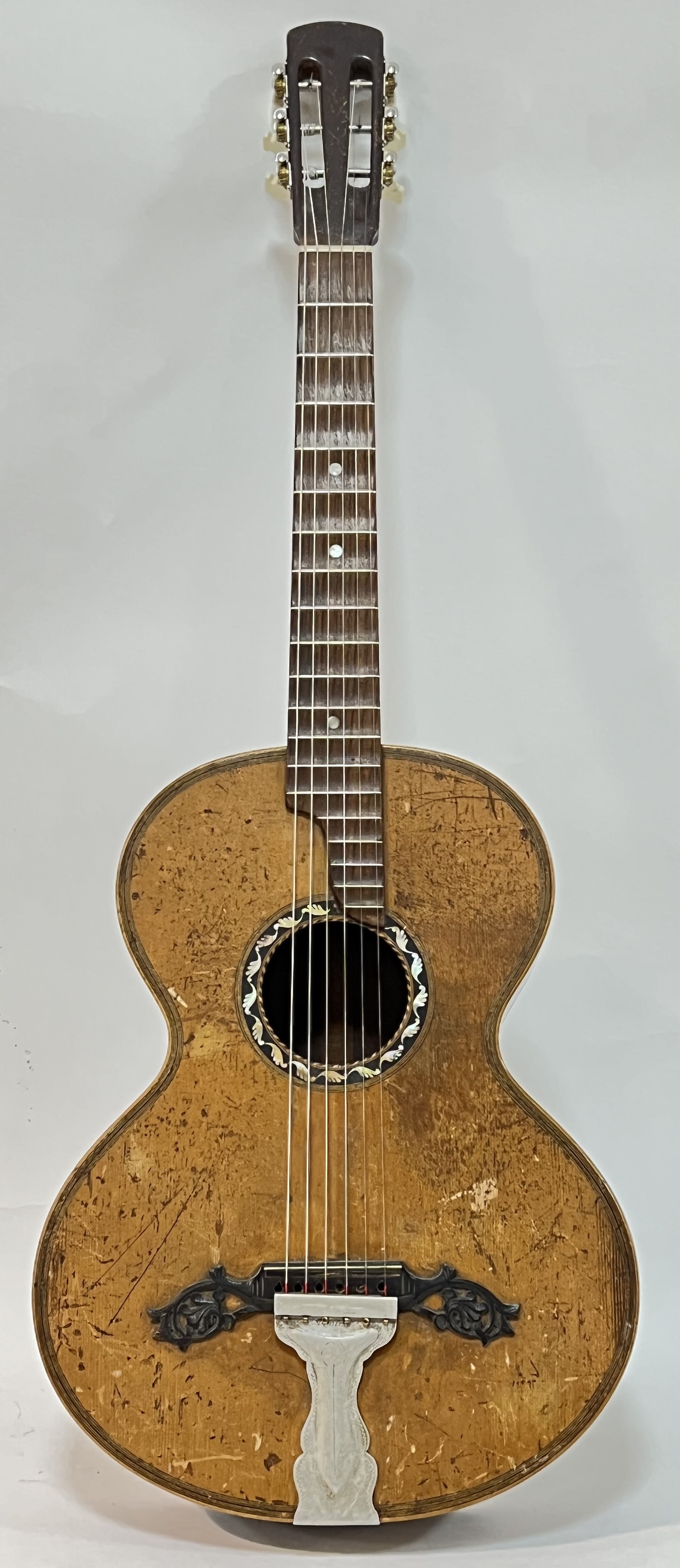 A vintage spruce and rosewood acoustic guitar, the tailpiece marked Dreima, the sound hole with