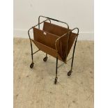 A vintage mid century magazine rack, the gilt metal frame with faux leather divisions moving on