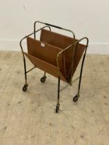 A vintage mid century magazine rack, the gilt metal frame with faux leather divisions moving on