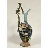 A large hand-painted in the style of French barbotine majolica pottery jug vase with floral