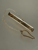 A modern 9ct gold tie clip with stamped border and safety chain and button loop L x 5.2g 3.34g