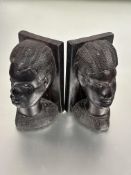 A pair of African carved ebony mask bookends H x 20cm L x 12cm W x 11cm