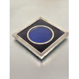 A Edwardian London silver square shaped photograph frame with inner circular aperture and velvet