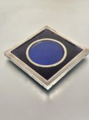 A Edwardian London silver square shaped photograph frame with inner circular aperture and velvet