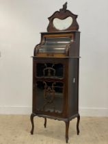 A late Victorian mahogany side cabinet, the raised back with serpentine glazed door opening to a
