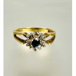 A 18ct gold zircon and diamond cluster ring mounted in claw setting with open sides missing two