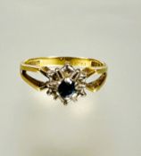 A 18ct gold zircon and diamond cluster ring mounted in claw setting with open sides missing two