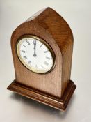A Edwardian oak inlaid lancet mantle clock with brass mounted white enamel dial and roman numerals