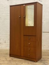 A mid century teak wardrobe by Symbol, full length door opening to an interior fitted with hanging