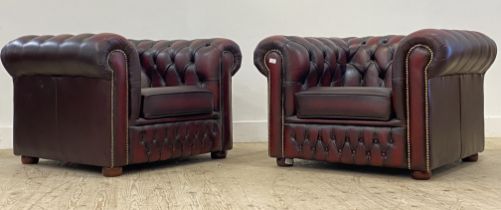 A pair of Vintage chesterfield club chairs, upholstered in deep buttoned oxblood leather. H70cm,