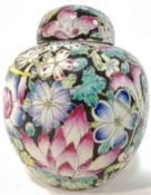 A Chinese famille noir enamelled porcelain ginger jar decorated with exotic flowers against a
