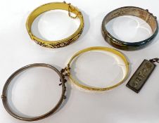 A group of four bangles comprising a Smith and Ewen Chester hallmarked silver bangle, two gold