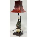 An patinated cast metal OKA lamp modelled as a Chinese scholar with red tapered shade (h- 49cm)