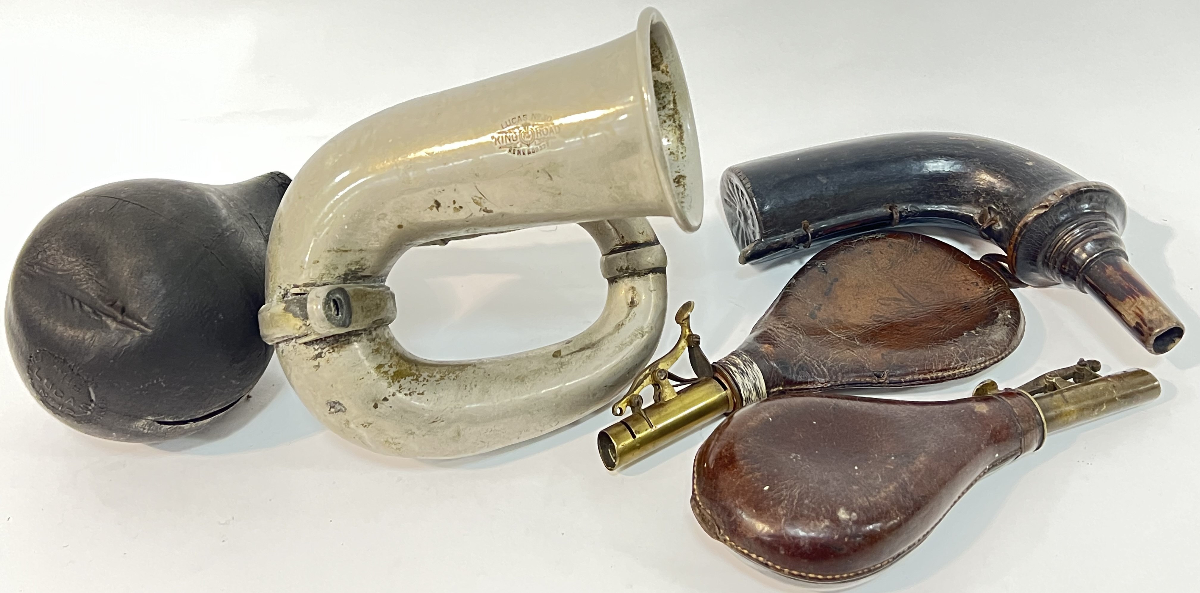 A vintage Lucas "King of the Road" motoring horn together with a pair of brass and leather powder