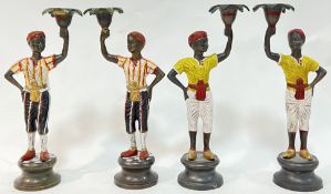 Two pairs of Emma Poland cast bronze figural candle holders modelled as boys in the Orientalist