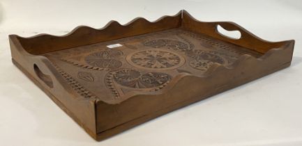 An eastern teak twin handled drinks tray carved with floral motifs. 54cm x 39cm.