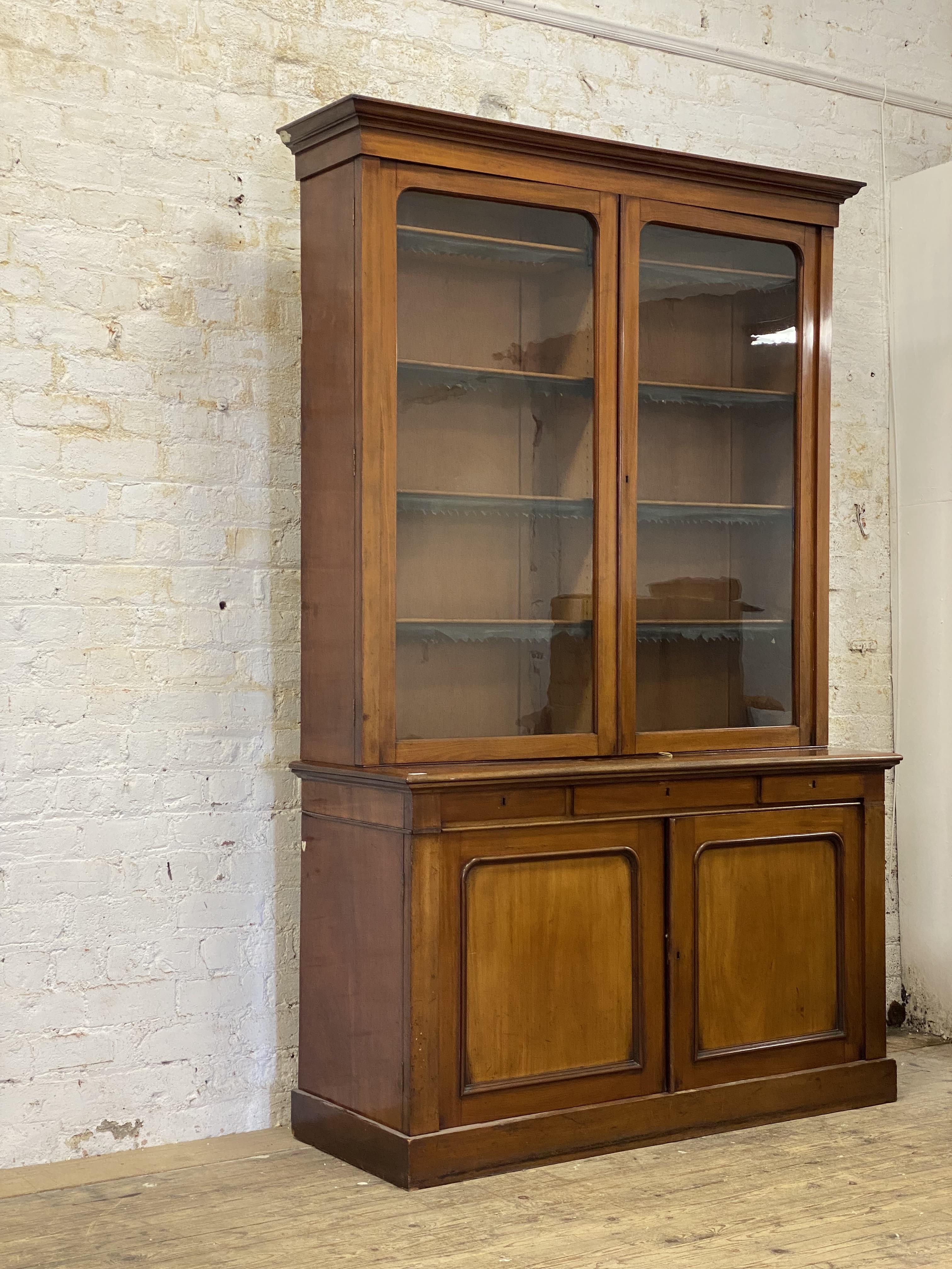An Edwardian law office two  part mahogany bookcase, the projecting cornice above two glazed doors