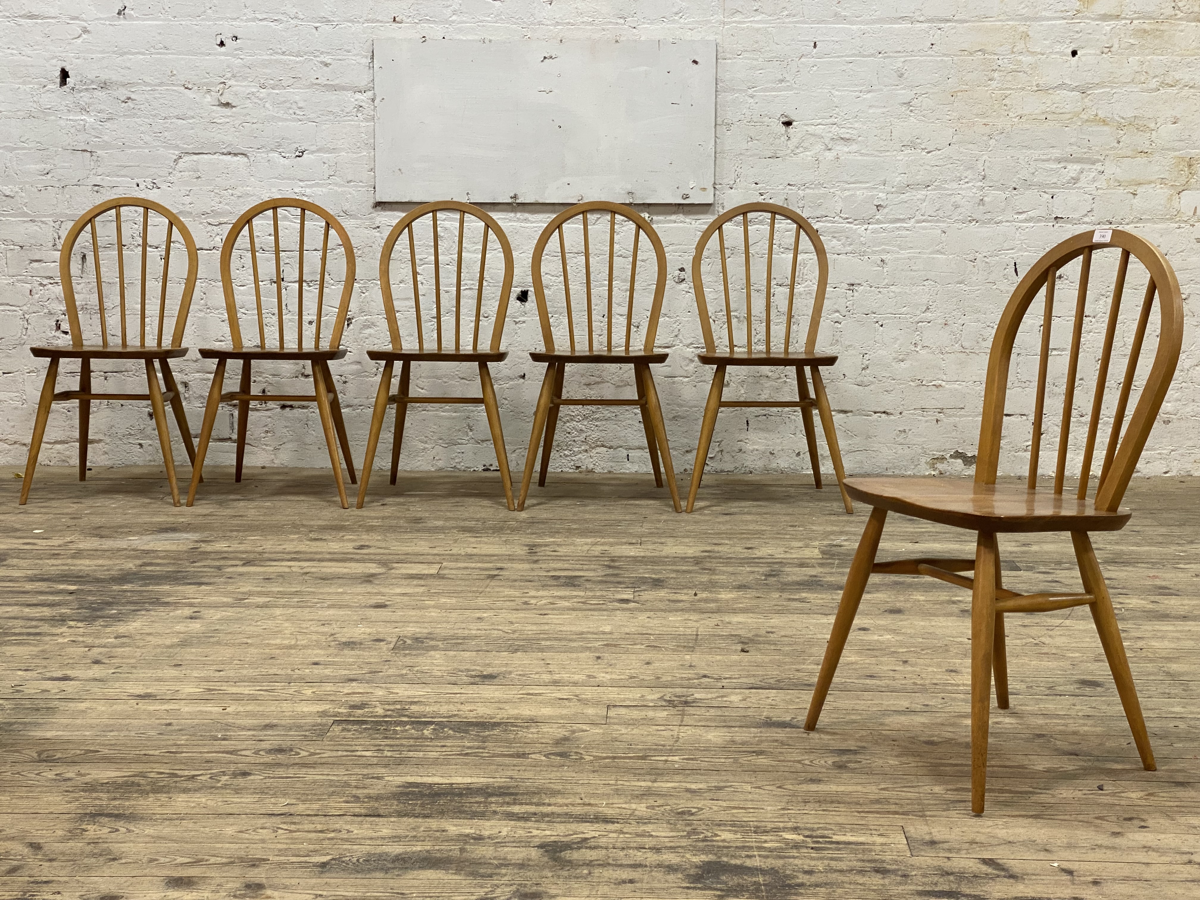 Ercol, a set of six elm and beech dining chairs, hoop and spindle back over saddle seats and