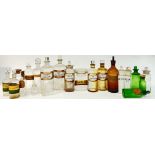 A quantity of clear and green glass chemist/apothecary jars/bottles, including some with gilt