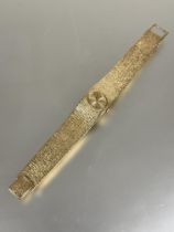 A ladys 9ct gold Bueche -Girod vintage 1960s wristwatch with oval gilt dial and baton hour markers