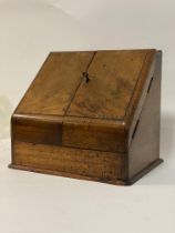 A Victorian walnut stationary casket of sloped form, the front opening to a fitted interior and