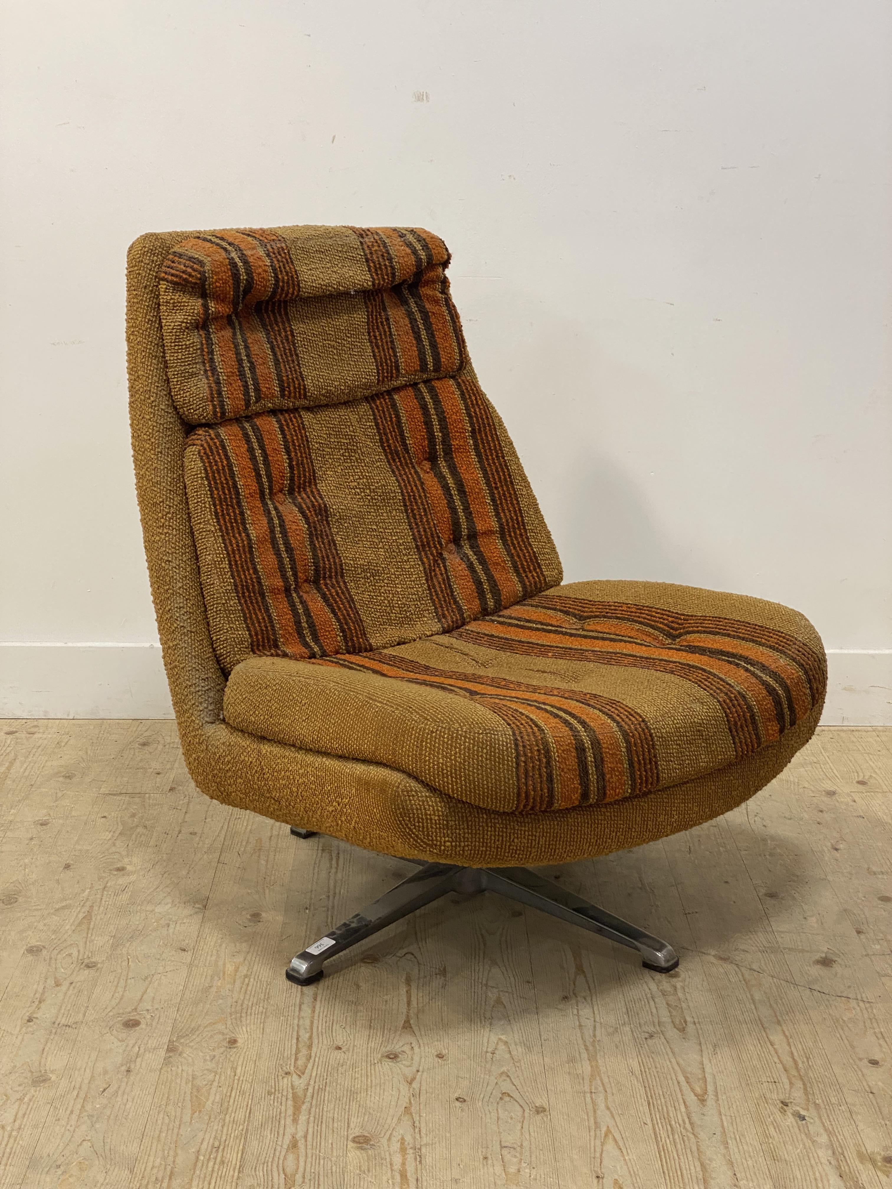 A 1970's upholstered lounge chair, swivelling on a four point chrome base. H92cm.