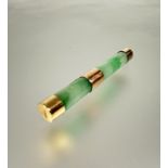 A Chinese 22ct gold mounted celadon jadeite barrel brooch with original clasp fastening shows no