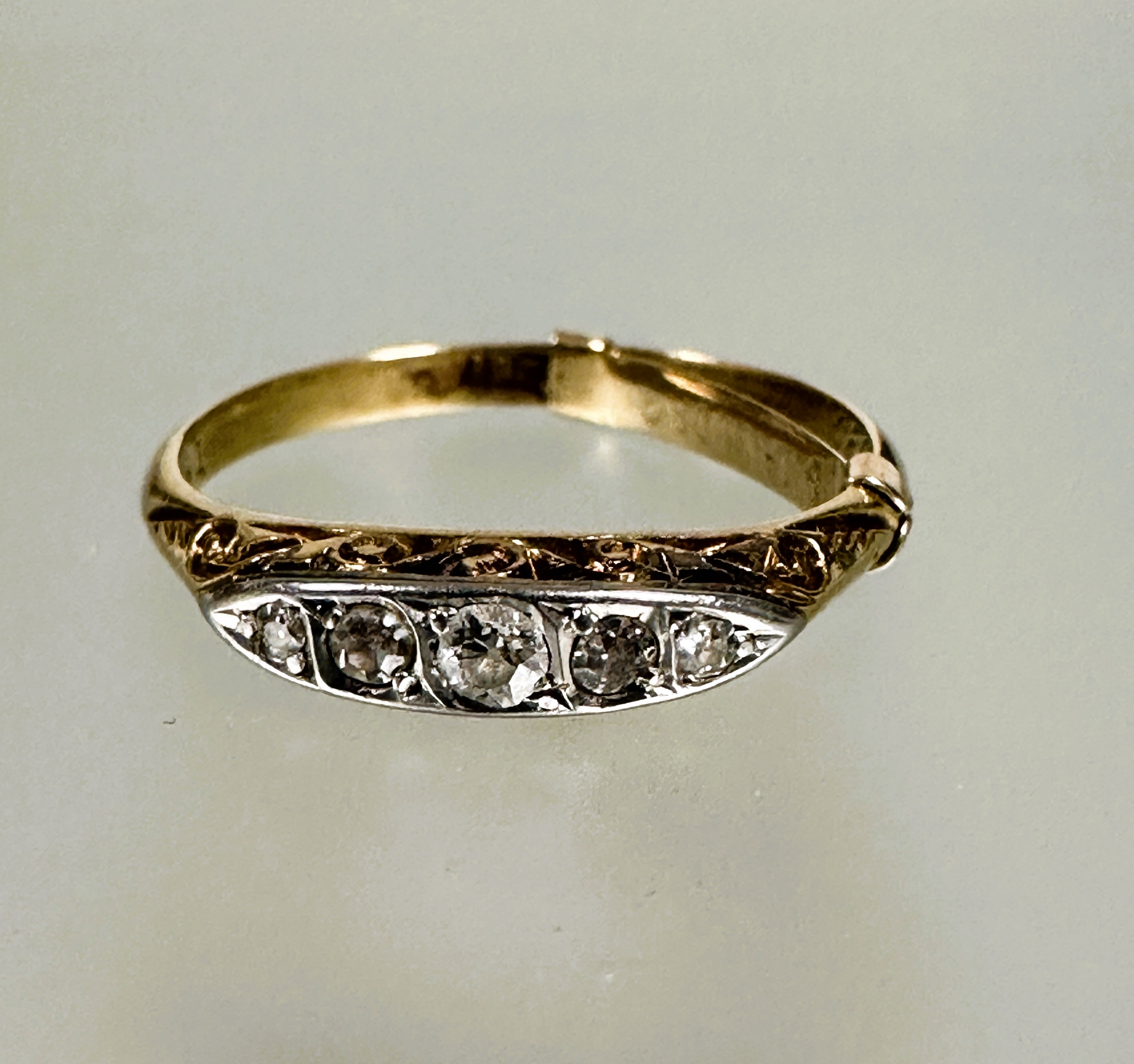A 18ct gold five old mine cut graduated diamond set ring, the center stone approximately 0.03ct with