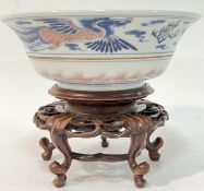 A Chinese porcelain bowl decorated with phoenix and dragon in underglaze red and cobalt blue (