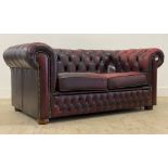 A vintage chesterfield two seat sofa, upholstered in deep buttoned oxblood leather. H70cm, L155cm,