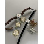 A collection of five various ladys wrist watches and two St George and Dragon metal brooches (A