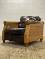 John Lewis, a Vintage bergere armchair, hardwood frame with double cane sides enclosing leather