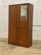A good mid century teak wardrobe by Symbol, full length door opening to an interior fitted with