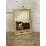 A contemporary wall hanging mirror with bevelled plate. 73cm x 102cm.