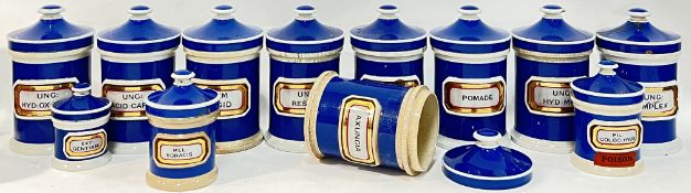 A collection of Victorian ceramic blue apothecary jars with verre eglomise gilt labels (some