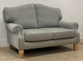 Isla Mae, a traditional two seat sofa, well upholstered in herringbone / tweed wool fabric, raised