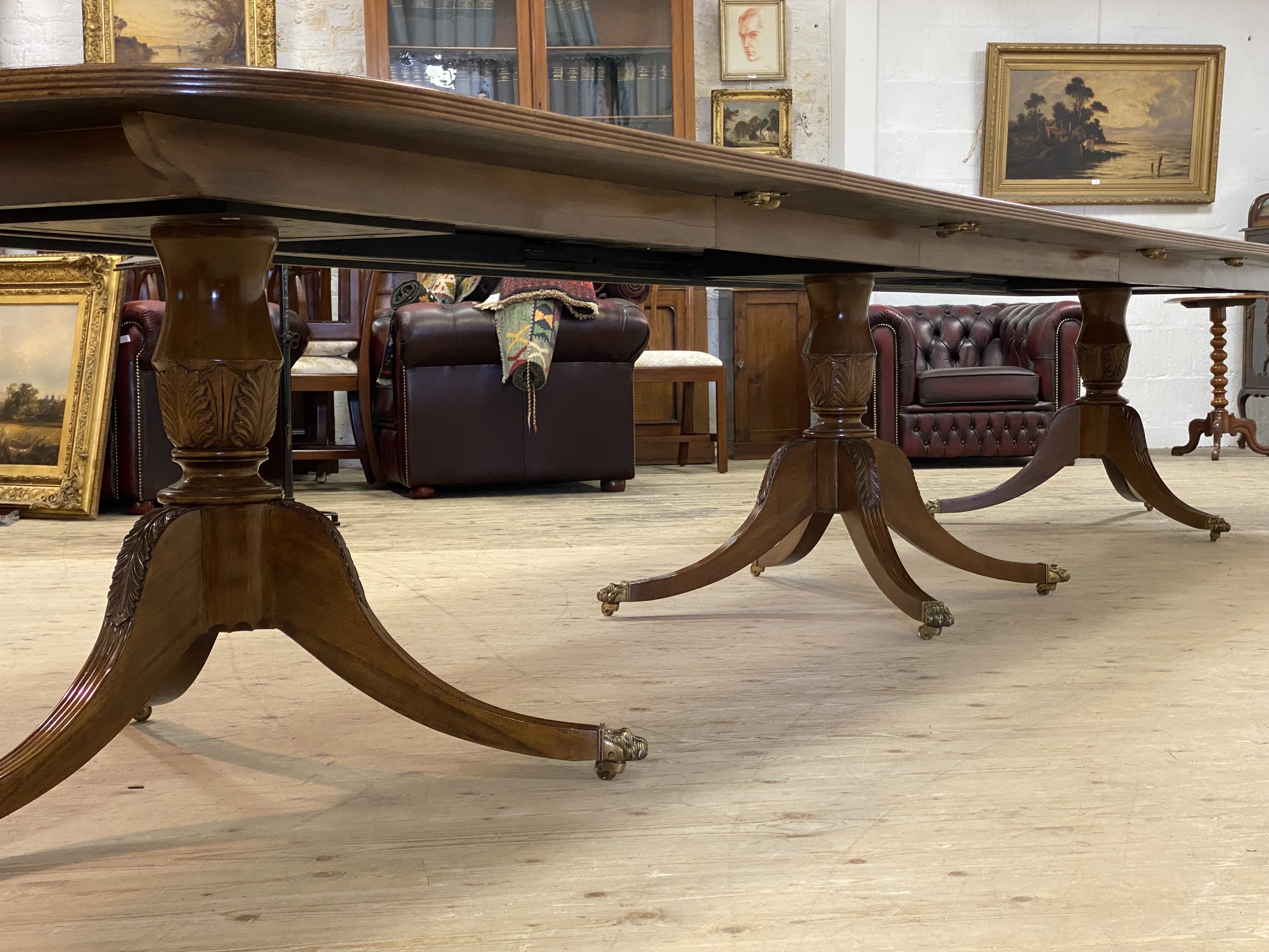 A monumental burr walnut triple pedestal dining table in the Regency style, the cross banded top - Image 3 of 3