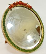 A 1930s Barbola type circular mirror decorated with fruits and flowers to top and green ribbon to