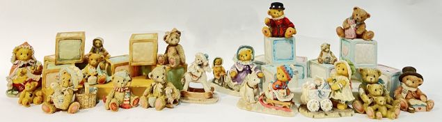 A large group of Priscilla Hillman "Cherished Teddies" collectible ceramic bear figures with two