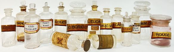 A group of various clear glass apothecary jars with gilt paper labels and verre eglomise labels (