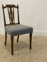 An Edwardian walnut side chair in the Neo-Classical style, with upholstered seat and raised on