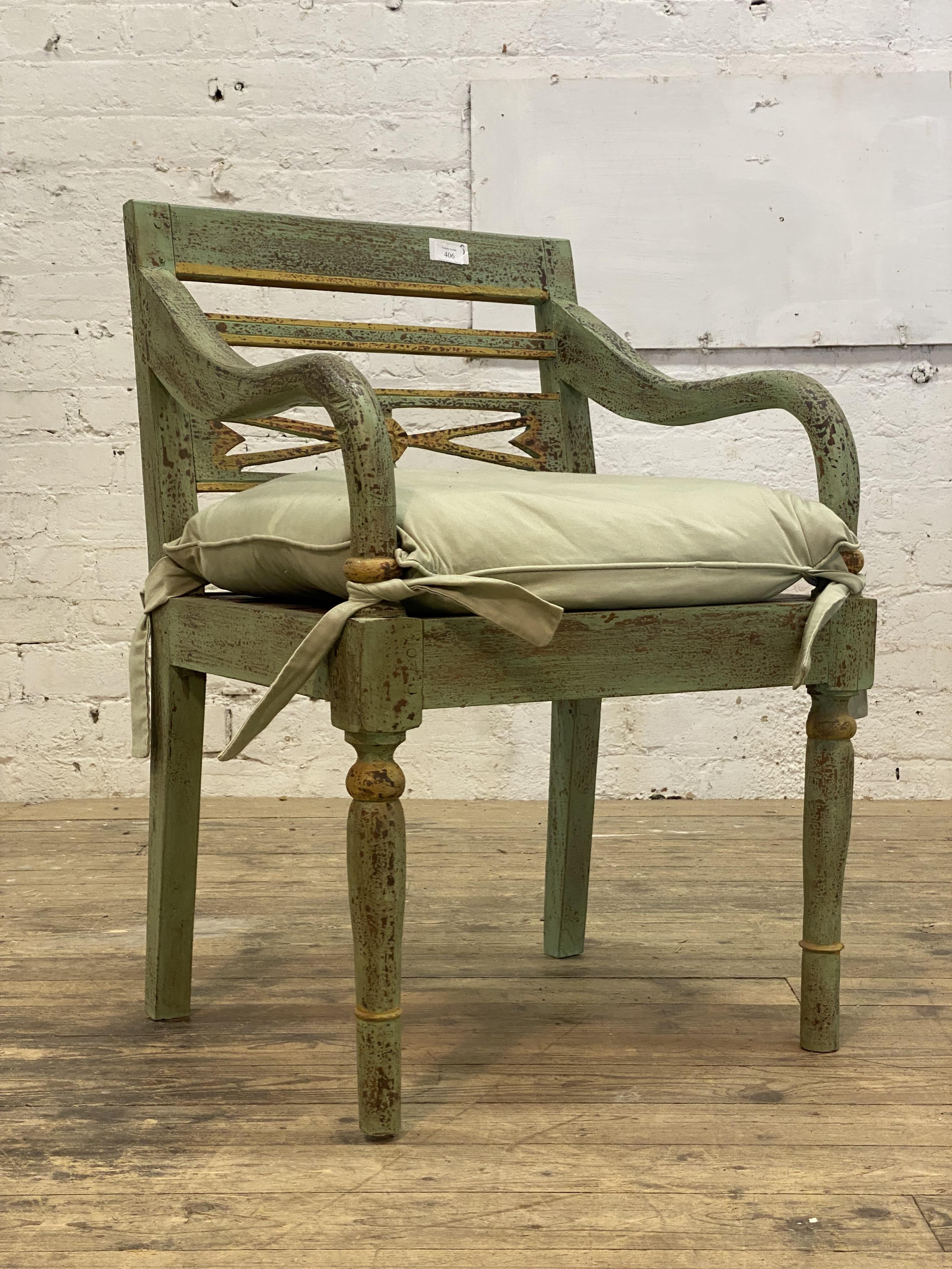 A 19th century style hardwood elbow chair, finished in distressed green and gilt paint. H87cm.