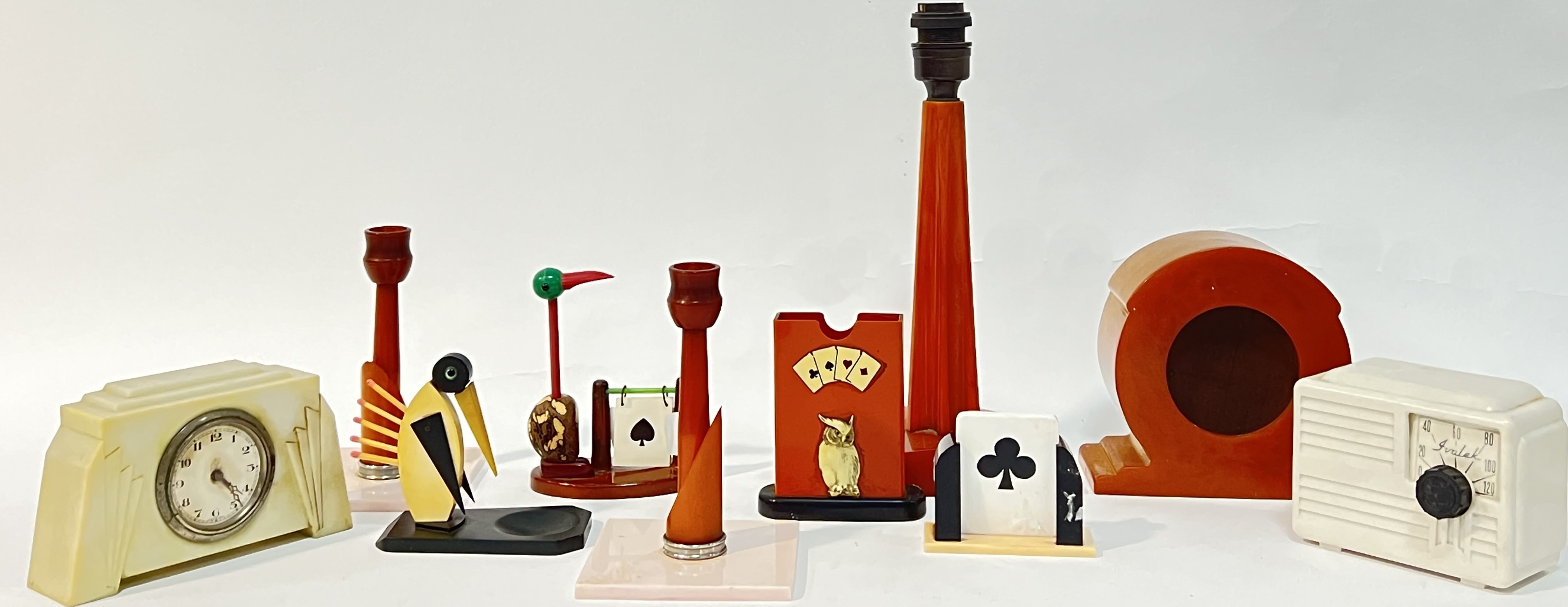 A quantity of bakelite/early plastic objects comprising two bridge trump suit indicators, a deck